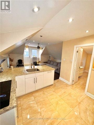 Toronto (Yonge-Eglinton) apartment for rent - A kitchen with a sink and cabinets under a window.