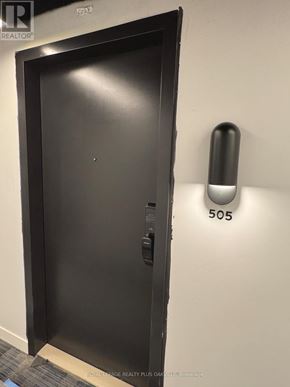 Burlington (Alton) condo for rent - A black door with a handle and a number 505 on the wall.