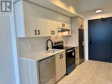 Burlington (Alton) condo for rent - A kitchen with white cabinets and black appliances.