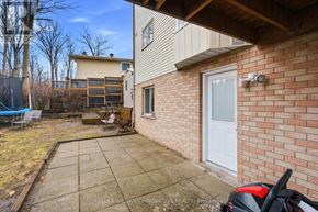Kitchener apartment for rent - A backyard with a patio and a brick wall.