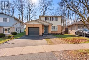 Kitchener apartment for rent - A house with a driveway and a car parked in front.