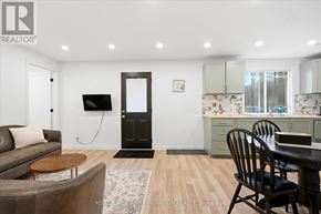 Kitchener apartment for rent - A modern living room with a brown couch and a wooden coffee table.
