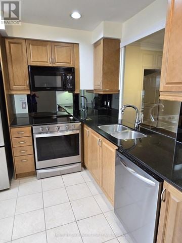 Toronto (Banbury-Don Mills) condo for rent - A kitchen with wooden cabinets and black countertops.