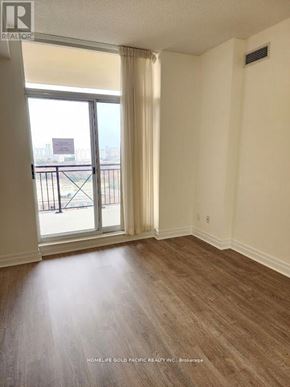 Toronto (Banbury-Don Mills) condo for rent - A room with a view of a balcony through a sliding glass door.