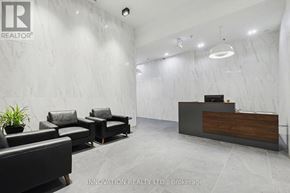 Ottawa condo for rent - A reception area with a wooden desk and black leather chairs.