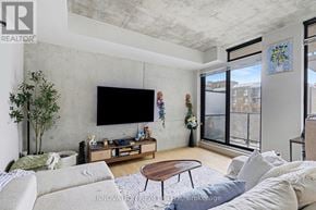 Ottawa condo for rent - A living room with a flat screen TV mounted on the wall.