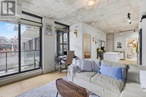 Ottawa condo for rent - A living room with a couch and a chair.