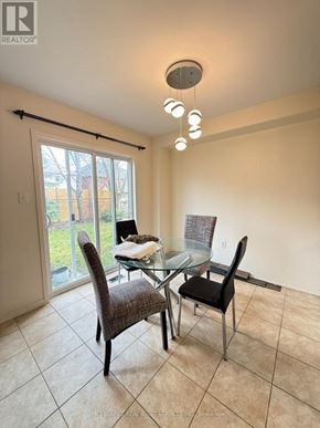 Oshawa (Windfields) apartment for rent - A dining room with a glass table and chairs.