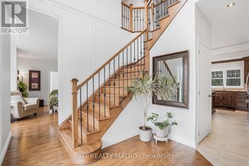 Champlain apartment for rent - A living room with a staircase and a painting on the wall.