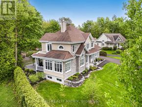 Champlain apartment for rent - A large house with a well-manicured lawn and trees surrounding it.