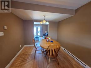 Labrador City apartment for rent - A dining room with a wooden table and chairs.