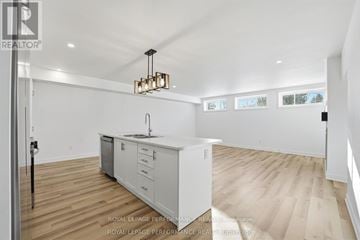 Russell apartment for rent - A kitchen with white cabinets and a wooden floor.