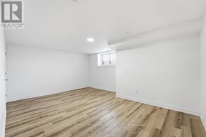 Russell apartment for rent - A spacious room with wooden flooring and white walls.