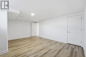 Russell apartment for rent - A white room with wooden floors and two doors.