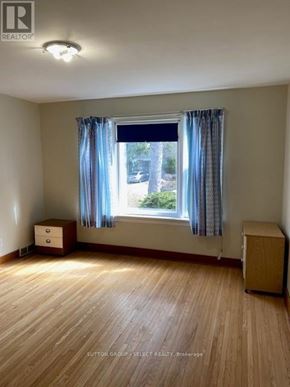 London North (North K) triplex for rent - A room with a window and a wooden floor.
