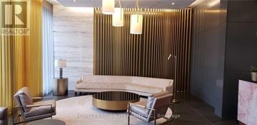 Toronto (Bayview Village) house for rent - A modern living room with a white sofa and a gold coffee table.