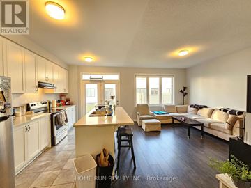 Ottawa townhouse for rent - A well-lit kitchen and living room with a dining table and chairs.
