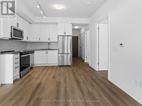 Vaughan (Beverley Glen) condo for rent - A kitchen with white cabinets and a wooden floor.
