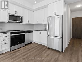 Vaughan (Beverley Glen) condo for rent - A kitchen with white cabinets and appliances.