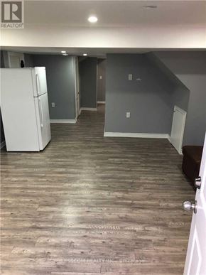Brampton (Sandringham-Wellington) apartment for rent - A room with a white fridge and wooden flooring.