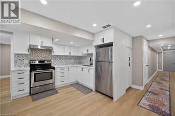 Hamilton apartment for rent - A modern kitchen with white cabinets and stainless steel appliances.