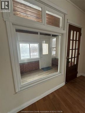 Windsor apartment for rent - A room with a large window and a wooden floor.