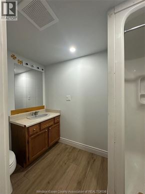 Windsor apartment for rent - A bathroom with a toilet, sink and mirror.