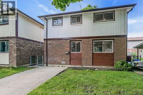 Windsor apartment for rent - A two-story house with a red door and a garage door.