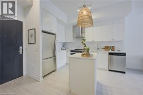 Kitchener condo for rent - A bedroom with a bed, nightstand, and window with curtains.