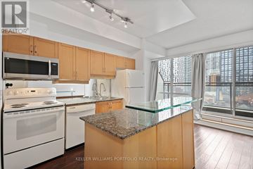 Toronto (Church-Yonge Corridor) condo for rent - A kitchen with a granite counter top and a view of the city.