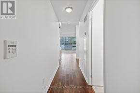 Toronto (Church-Yonge Corridor) condo for rent - A long hallway with a white wall and a window.