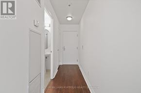 Toronto (Church-Yonge Corridor) condo for rent - A long hallway with white walls and wood floors.