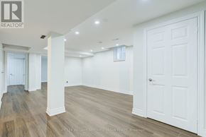 Toronto (Rouge) apartment for rent - A spacious room with white walls and wooden flooring.
