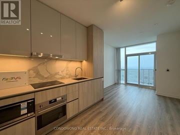 Vaughan (Vaughan Corporate Centre) condo for rent - A modern kitchen with wooden cabinets and stainless steel appliances.