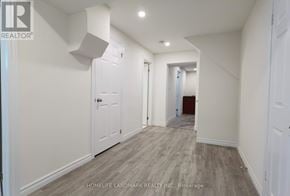 Newmarket (Huron Heights-Leslie Valley) apartment for rent - A hallway with white walls and wood flooring.