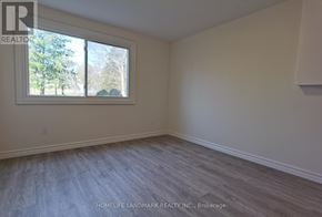 Newmarket (Huron Heights-Leslie Valley) apartment for rent - A room with a window and a wooden floor.