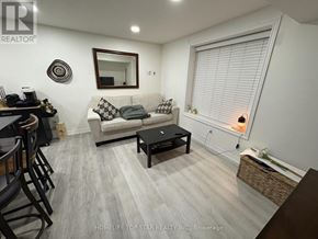 Vaughan (Maple) duplex for rent - A living room with a couch, coffee table, and a mirror on the wall.