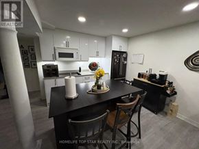 Vaughan (Maple) duplex for rent - A kitchen with a black countertop and white cabinets.