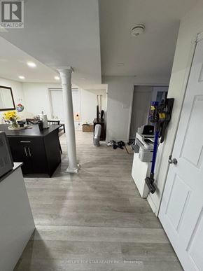 Vaughan (Maple) duplex for rent - A kitchen with a black counter top and white cabinets.