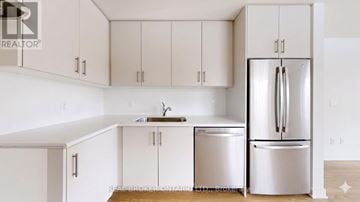 Aurora (Aurora Village) townhouse for rent - A kitchen with white cabinets and a white fridge.
