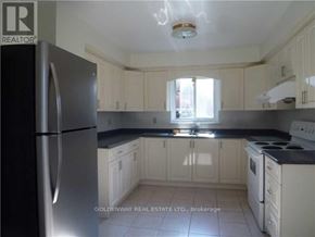 Toronto (Bayview Woods-Steeles) apartment for rent - A kitchen with white cabinets and a stainless steel refrigerator.
