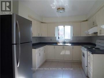 Toronto (Bayview Woods-Steeles) apartment for rent - A kitchen with white cabinets and a stainless steel refrigerator.