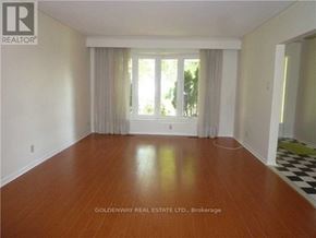 Toronto (Bayview Woods-Steeles) apartment for rent - A room with wooden flooring and a large window with curtains.
