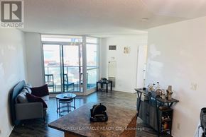 Toronto (Niagara) condo for rent - A living room with a couch, chairs, and a coffee table.