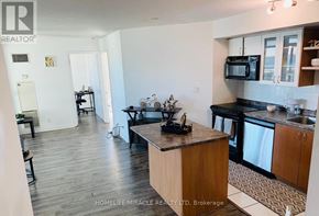 Toronto (Niagara) condo for rent - A kitchen with a brown countertop and black appliances.