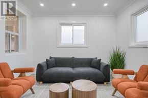 Toronto (South Riverdale) apartment for rent - A living room with a grey couch, orange chairs, and a wooden coffee table.