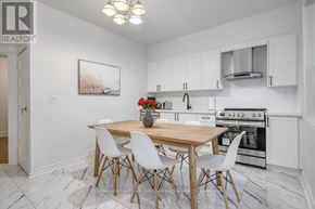 Toronto (South Riverdale) apartment for rent - A kitchen with a table and chairs in the middle of the room.