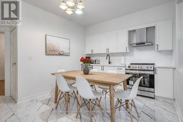 Toronto (South Riverdale) apartment for rent - A kitchen with a table and chairs in the middle of the room.