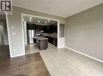 Milton apartment for rent - A kitchen area with a countertop and cabinets is visible through an open doorway.