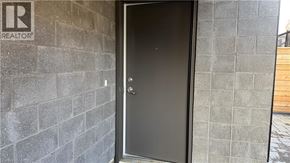 Kitchener townhouse for rent - A door with a glass panel is set in a brick wall.